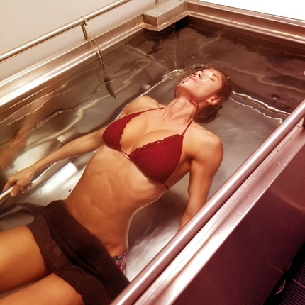 Woman in hydtrostatic body fat testing water tank